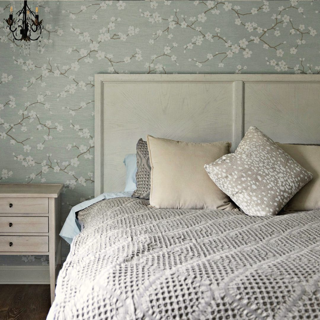 Bedroom with an upholstered headboard and layered neutral bedding